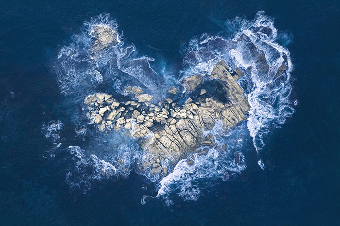 Waves and rocks in the shape of a heart