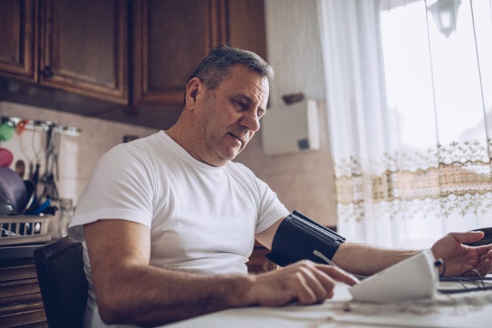 Middle age man reading in a kitchen