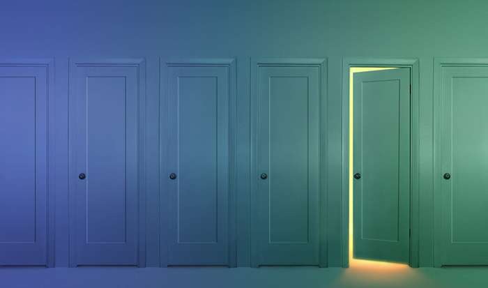 a row of doors, where one door is slightly open, and light spills out