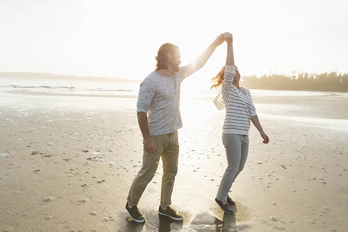 Couple walking at the beach at sunset