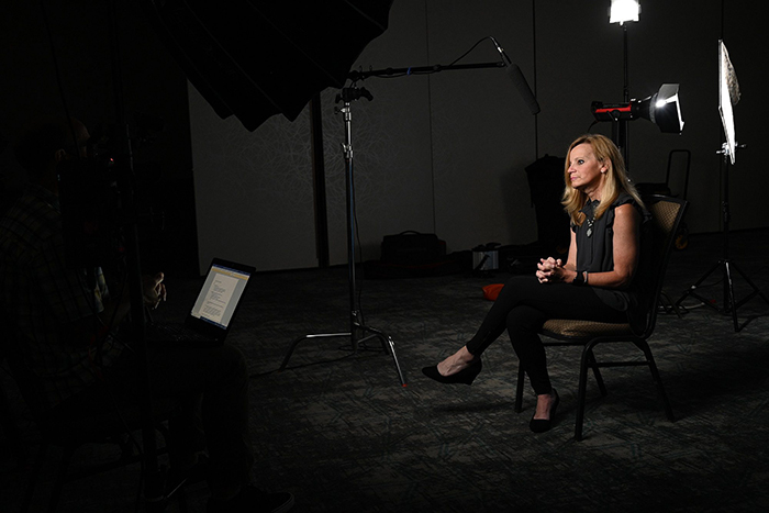 Jennifer sitting in a chair being interviewed