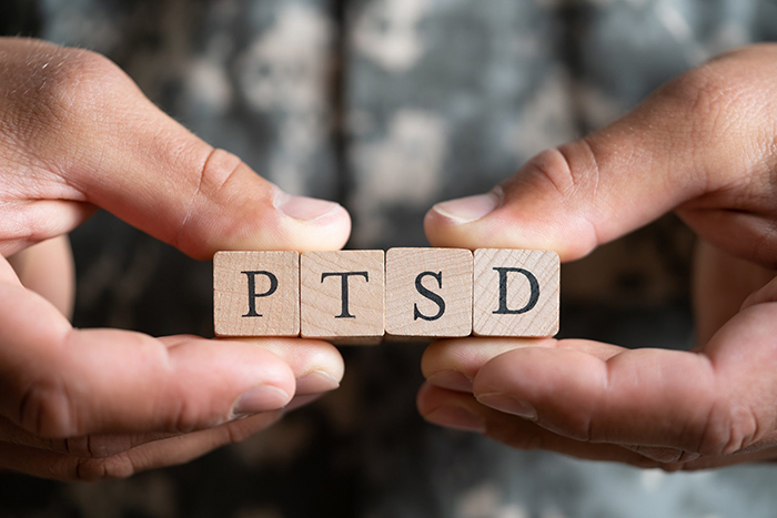 Man holding PTSD scrabble letters