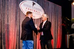 men shaking hands at high school football awards