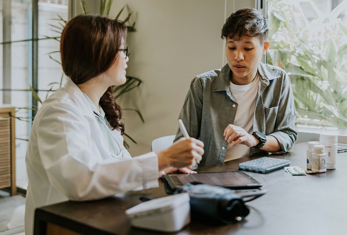 transgender or gender non-binary person speaking with a physician