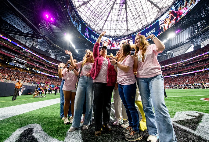 Breast cancer survivor Jill accompanied by family and friends was recognized on the field during the Atlanta Falcons' Crucial Catch game on September 29, 2024