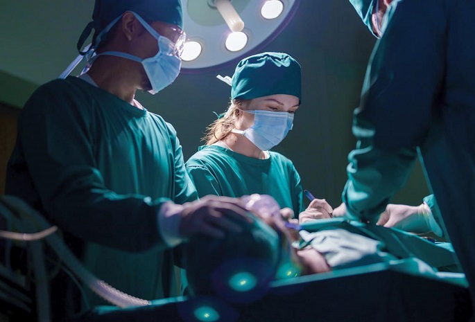 A surgical team cares for a patient