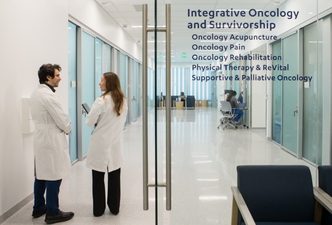 two providers stand outside Integrated Oncology department